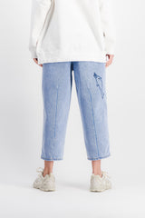 Wide-leg cropped light blue jeans with embroidered motifs